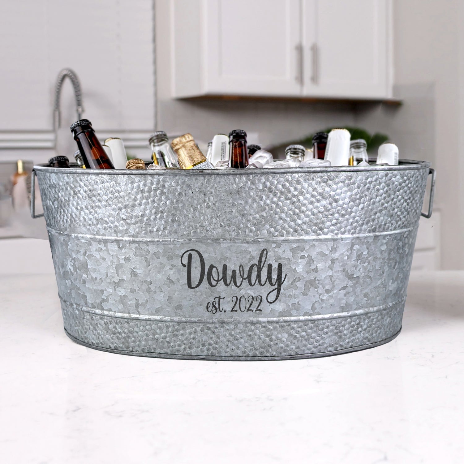 Personalized oval drink and ice cooler for chilling beverages at parties.  Chill beer, wine, champagne for a wedding, anniversary, or birthday party in the home or at an event space.