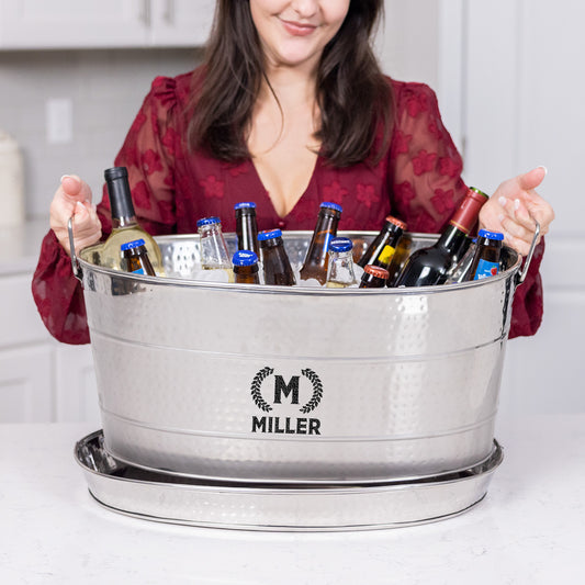 Personalized beverage tub with party tray for party use in the kitchen or the bar.  Constructed of food safe stainless steel and sealed to prevent leaking and rust.  Chill wine, beer, champagne, or other drinks with ice when sharing and serving party guests.  A custom message adds a special touch to the home, or to a thoughtful wedding, anniversary, or housewarming gift.