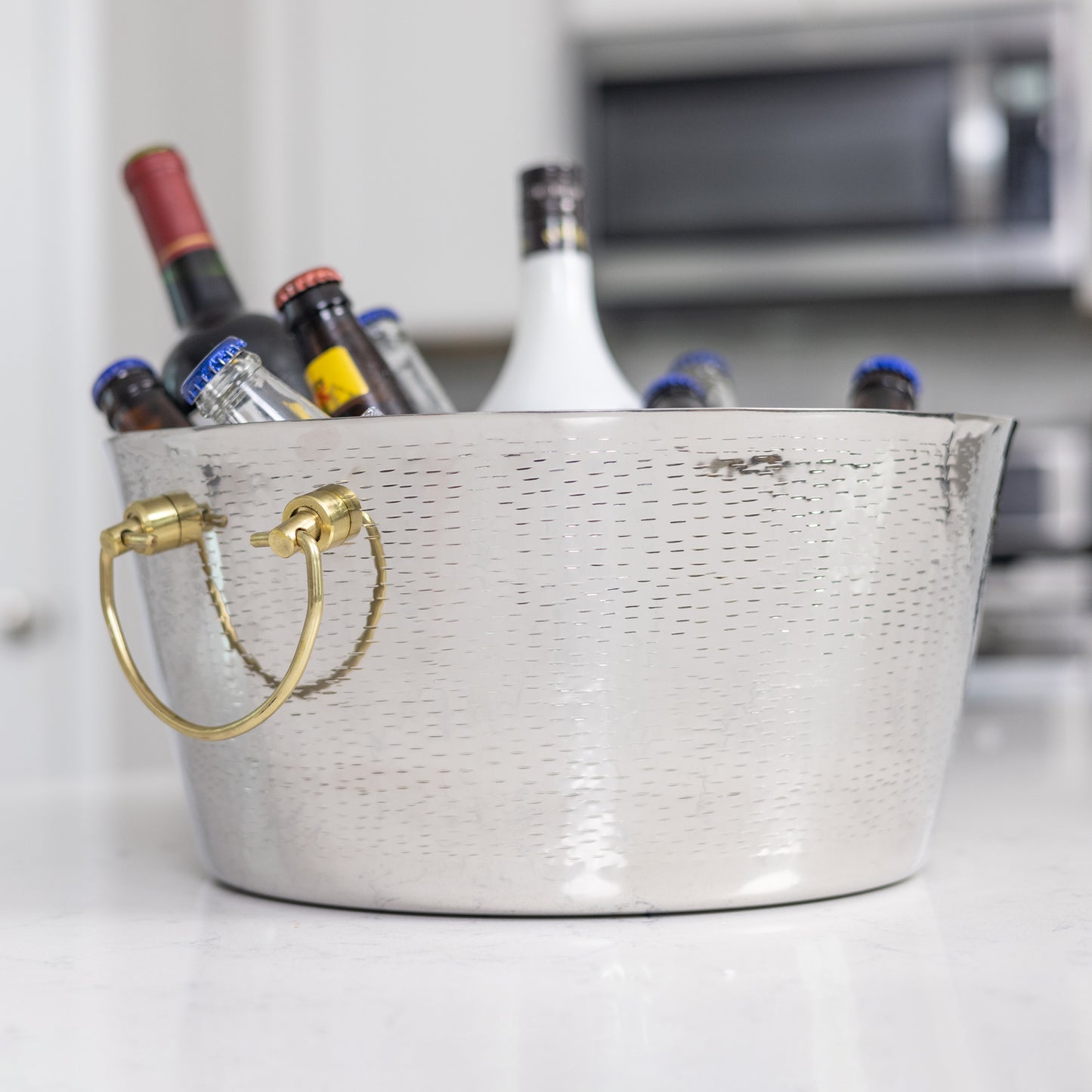 Round ice bucket with gold double hinged handles for easy and safe dumping of ice and water.  Heavy duty construction made of thick food safe stainless steel.  Easy to clean glossy mirrored finish, perfect for entertaining in the home or on the patio.