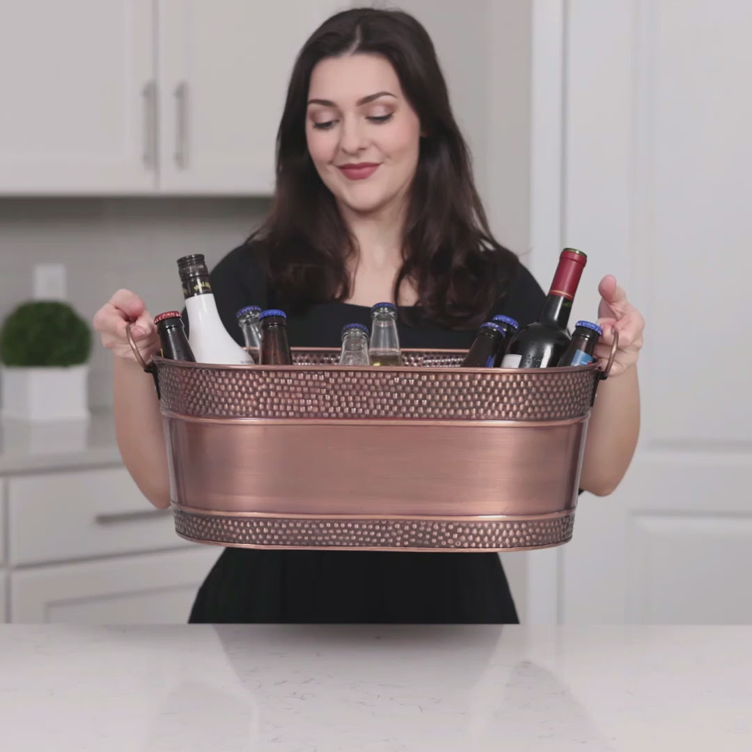Chill your drinks in style with this copper oval drink bucket to use for chilling and serving drinks at parties.