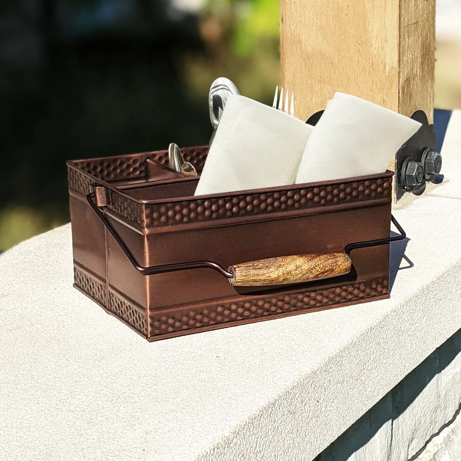 Condiment holder for condiments, napkins, or utensils when hosting a party or event.  Organizes and easily transports party essentials indoors to outdoors, from kitchen, to bar, to the patio.  Copper in color with hammered exterior.