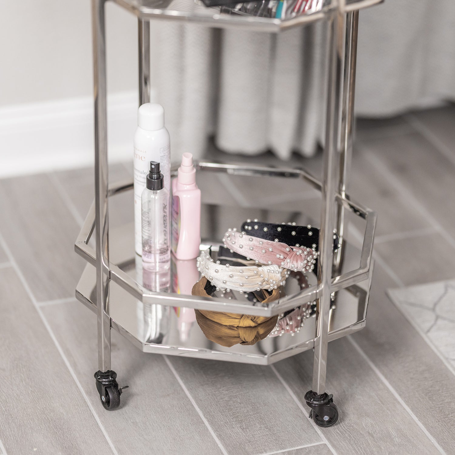 Small metal vanity with shelves to use in the bedroom or bathroom.  Holds personal items like makeup, hair accessories, body sprays, or perfumes.