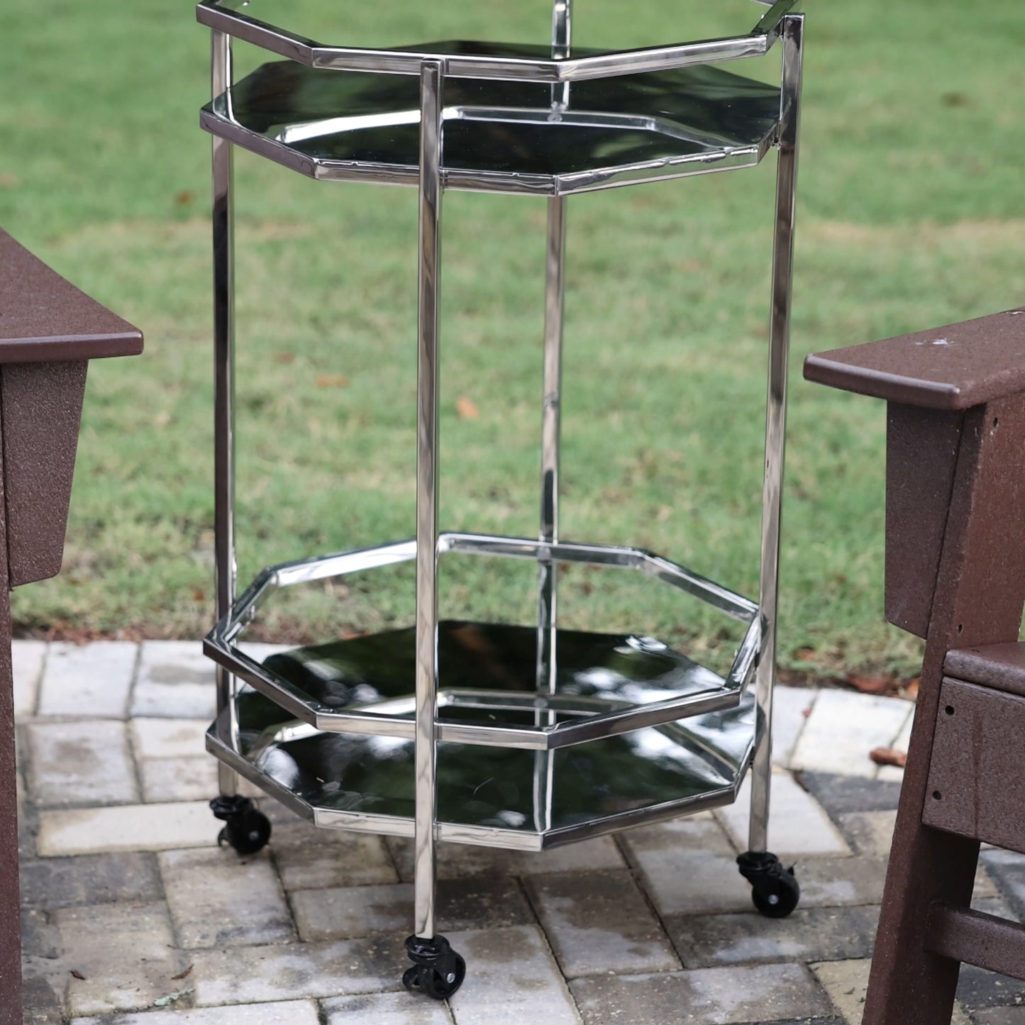 Bar cart with shelves to hold bar tools, wine, ice bucket, or wine bucket.  Includes wheels for easy rolling.  Use in the kitchen, bar, dining room, or on the patio.  Made of shiny stainless steel metal.