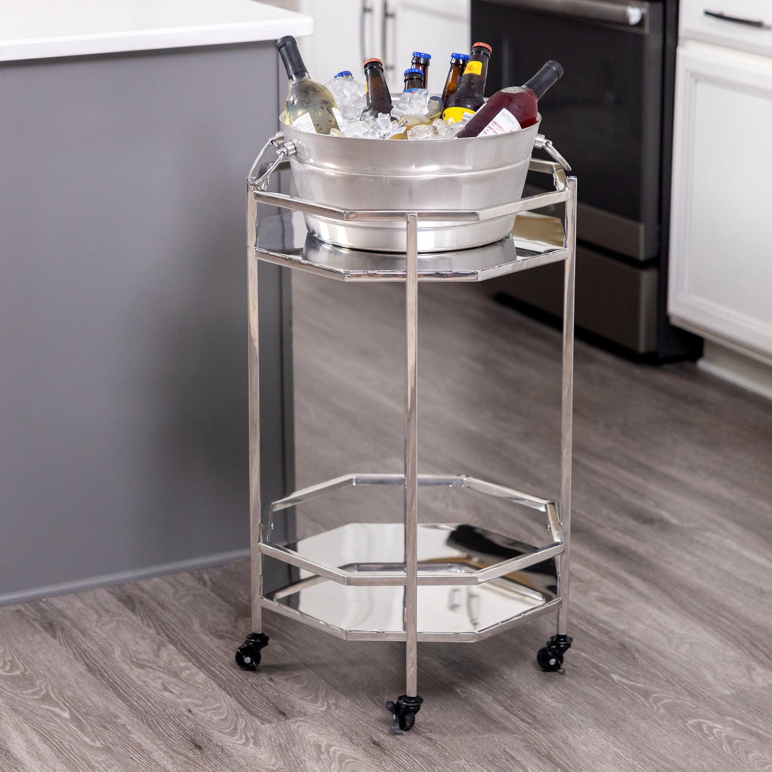 Metal bar cart that rolls can hold an ice bucket or wine bucket and be used in the bar, kitchen, or dining room when serving and entertaining at a party.